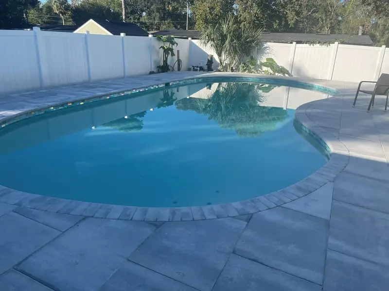 Freeform gunite pool, Pebble finish, travertine deck